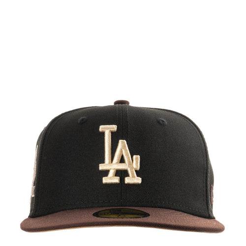 Two-tone black and brown baseball cap with raised LA logo on front