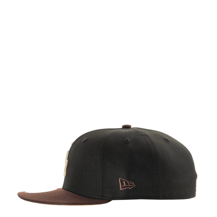 Two-tone black and brown baseball cap with New Era flag logo on side
