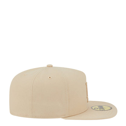Beige baseball cap with curved brim, side profile, and adjustable strap at back