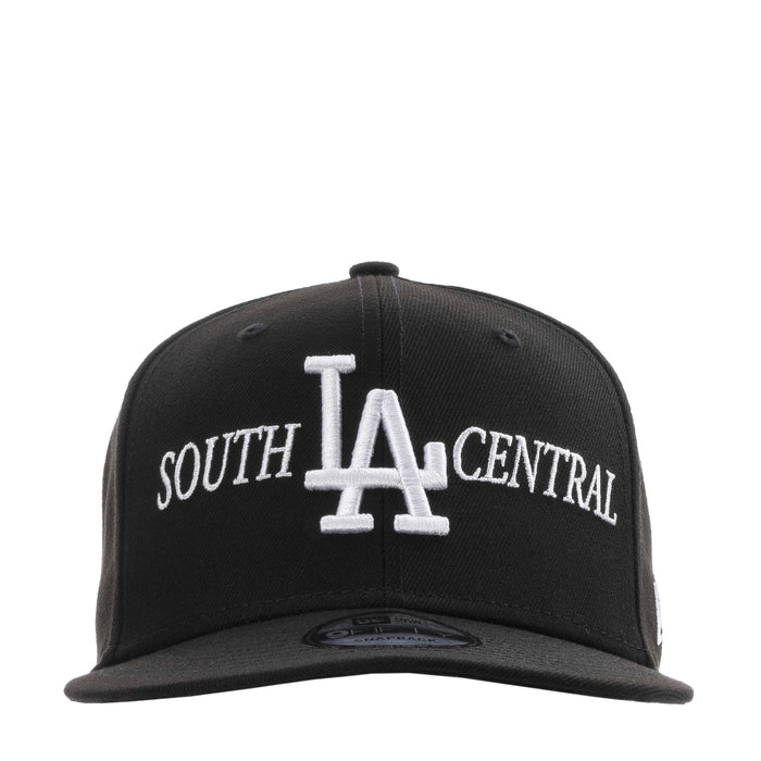 Black baseball cap with white LA and SOUTH CENTRAL embroidery, adjustable back strap