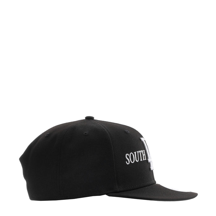 Black baseball cap with white SOUTH lettering on side panel, curved brim