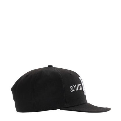 Black baseball cap with white SOUTH lettering on side panel, curved brim