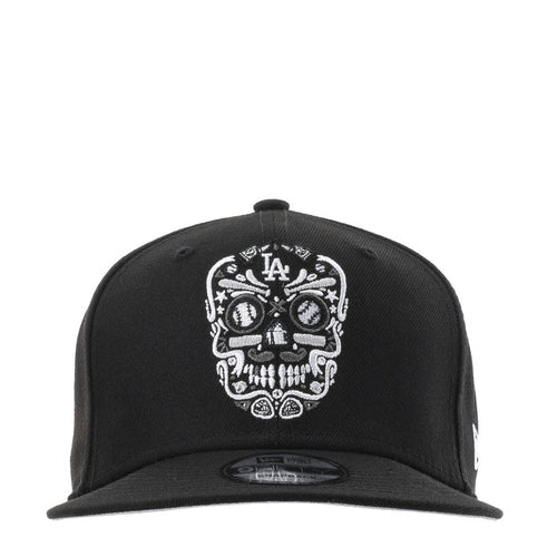Black baseball cap with white embroidered sugar skull and LA logo at front
