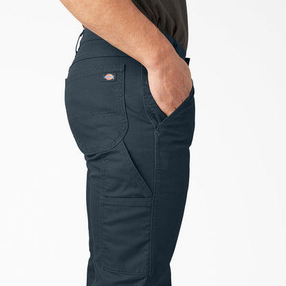 Mens dark blue carpenter pants, side cargo pocket and small logo patch close-up