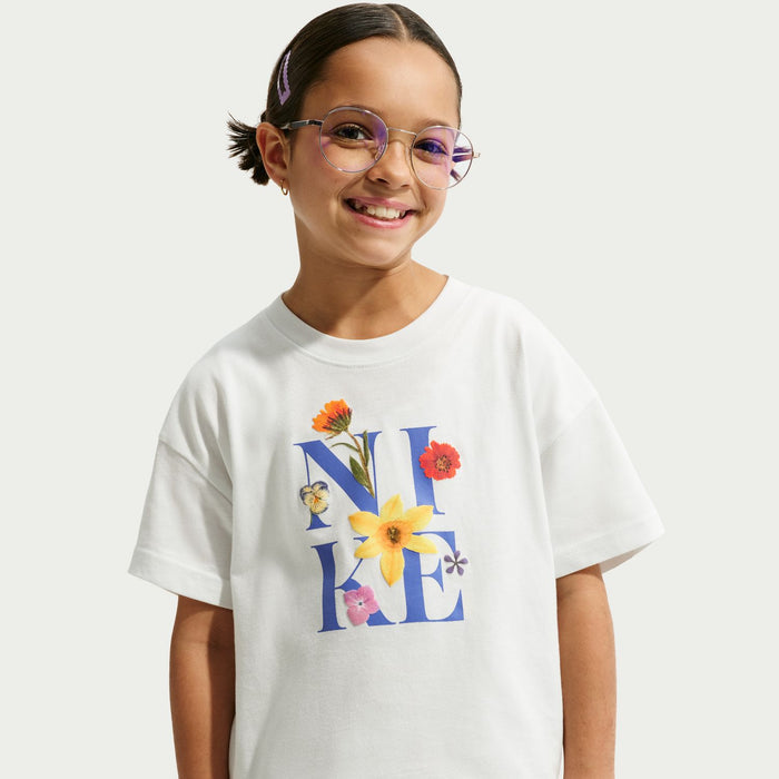 Youth boxy T-shirt in white with colorful flower “N A E” chest graphic