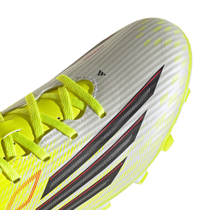 Men's soccer cleat close-up with neon yellow laces and textured upper detailing