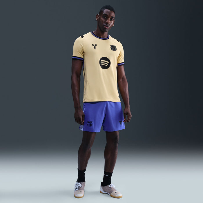 Men's soccer jersey in pale yellow with dark blue trim and large circular chest logo.