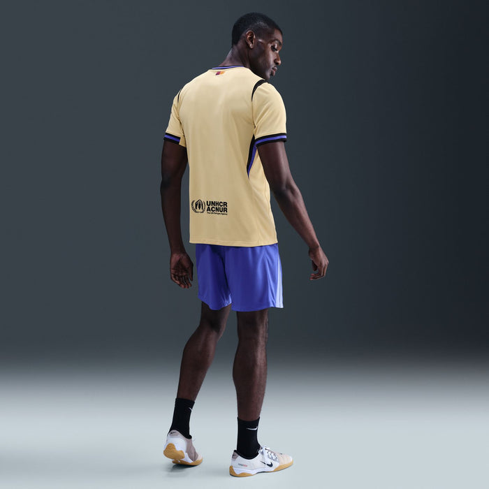 Men's soccer jersey in pale yellow with dark blue trim, UNHCR back logo at hem.