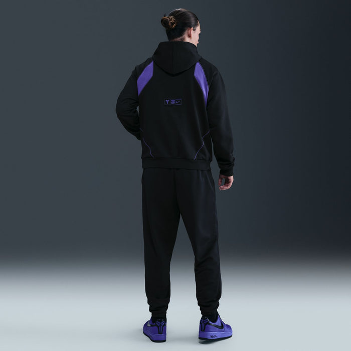 Men's black hoodie with purple back panel and kangaroo pocket, back view.