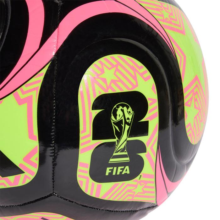 Black football close-up with FIFA trophy logo on neon lime and pink panel