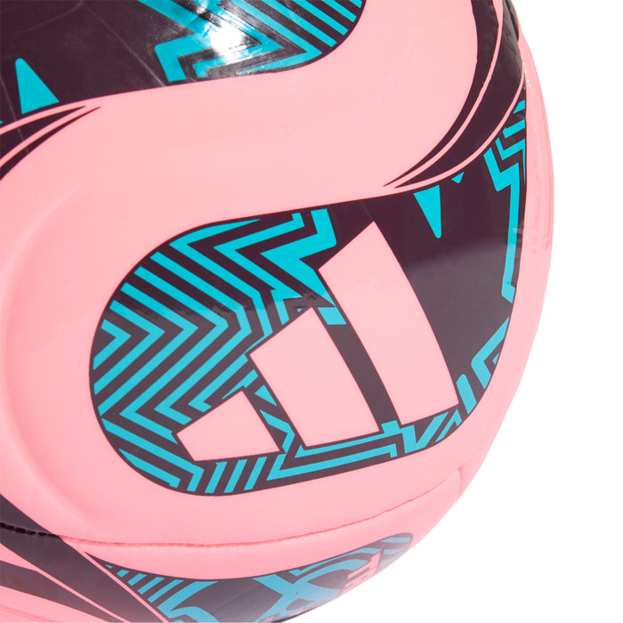 Pink soccer ball close-up with blue zigzag pattern and black diagonal stripe panel