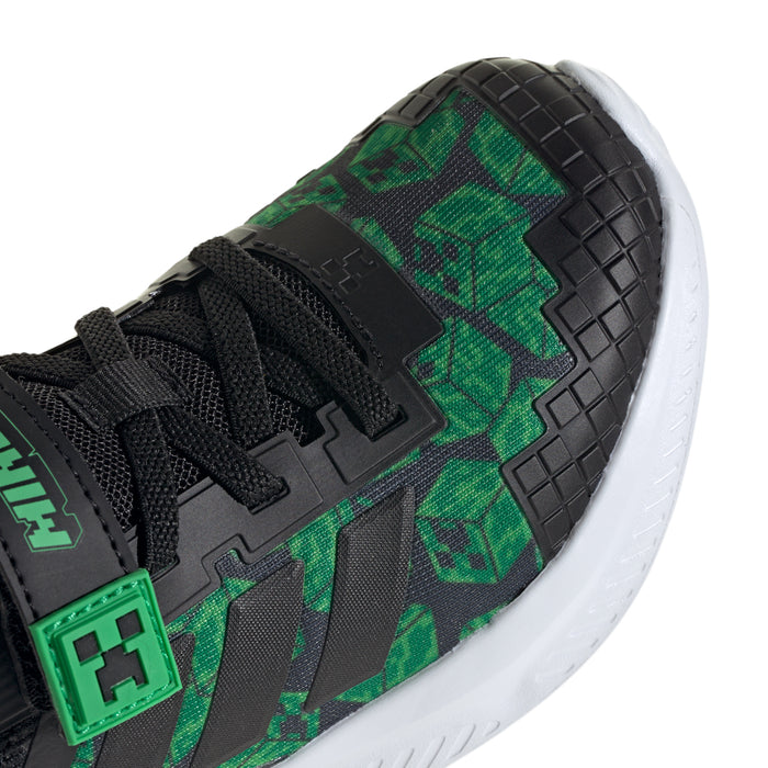 Kids' black sneaker close-up with green pixel pattern and grid-texture overlay