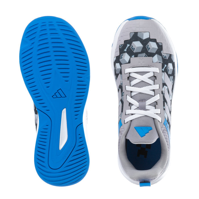 Youth running shoes outsole and toe view, blue tread, gray upper, white laces.