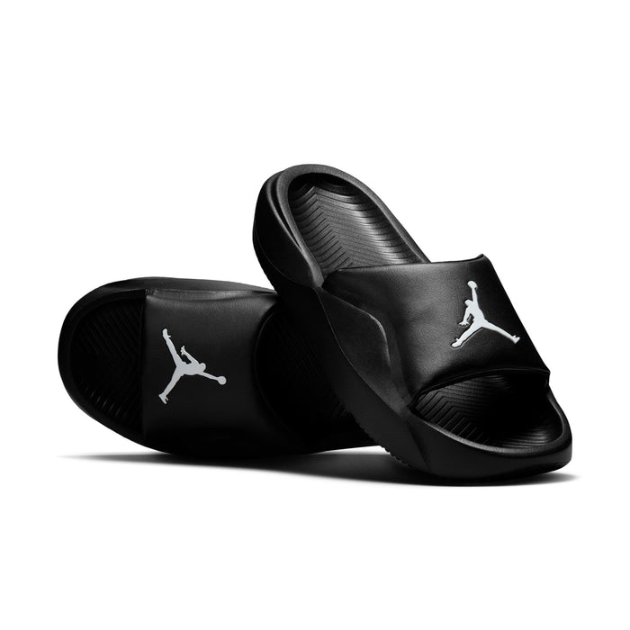 Black slide sandals angled view, white Jumpman logos on two straps