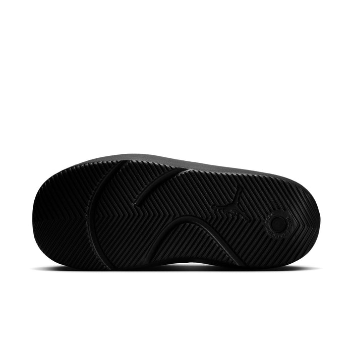 Black sandal outsole with herringbone tread pattern and circular grip detail