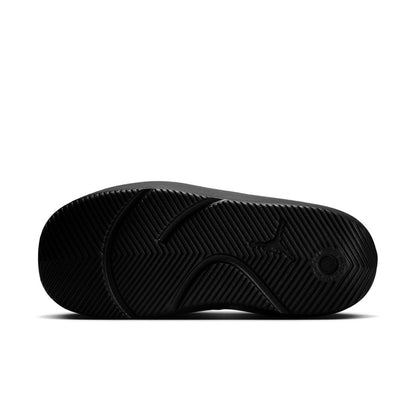 Black sandal outsole with herringbone tread pattern and circular grip detail