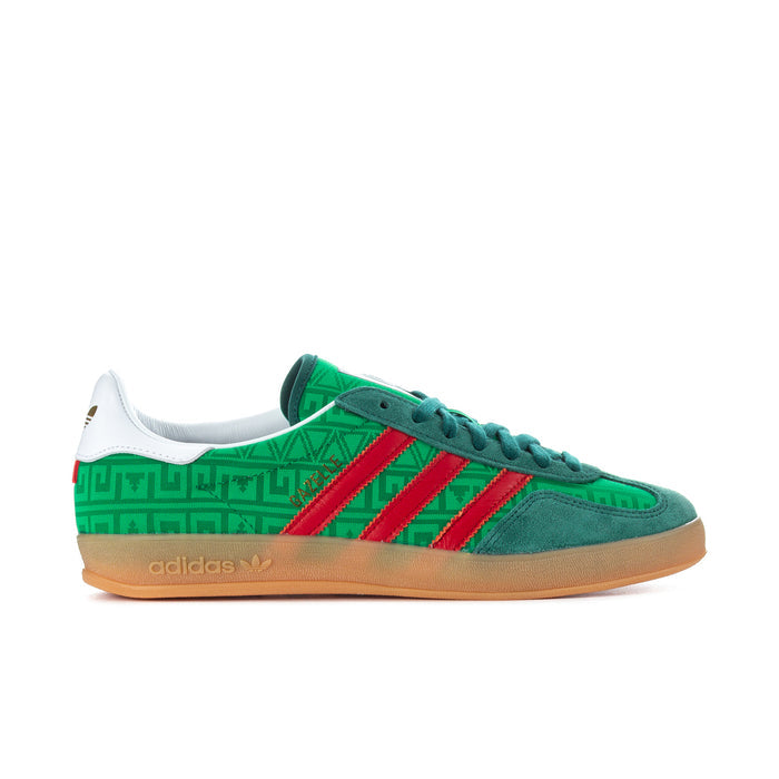 Green men's indoor sneakers with red adidas stripes, gum sole, white heel tab.