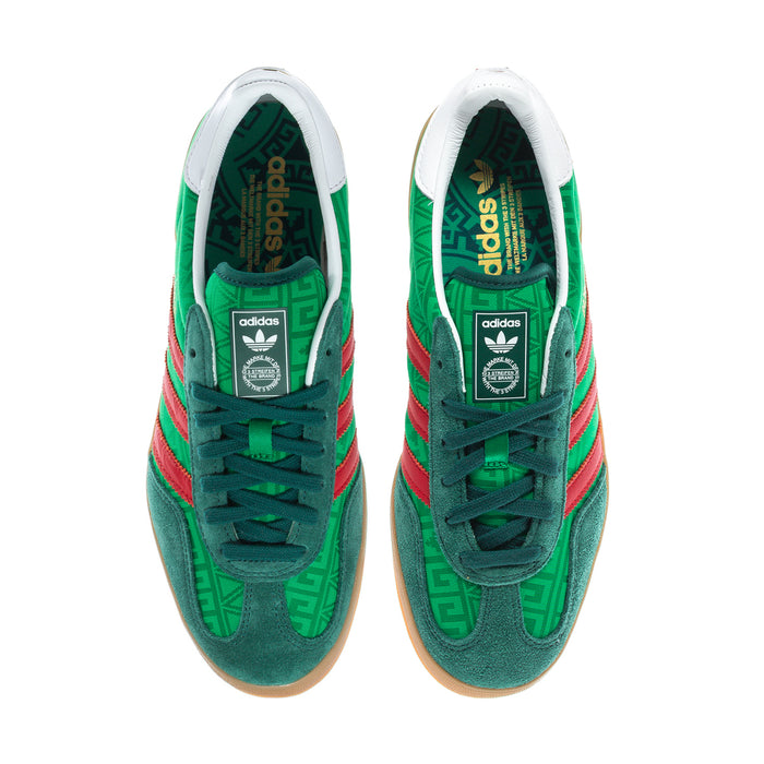 Green men's indoor sneakers with white tongues and red three-stripe detailing.