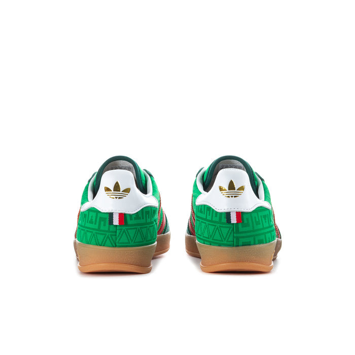 Green men's indoor sneakers with white heel panels and red stripe accents.