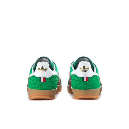 Green men's indoor sneakers with white heel panels and red stripe accents.
