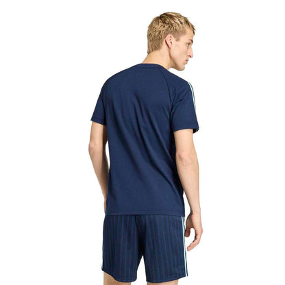 Men's navy tee back view with three white shoulder stripes and small hem logo.