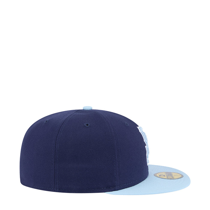 Two-tone baseball cap with dark navy crown and light blue brim, side view