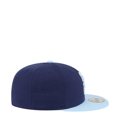 Two-tone baseball cap with dark navy crown and light blue brim, side view