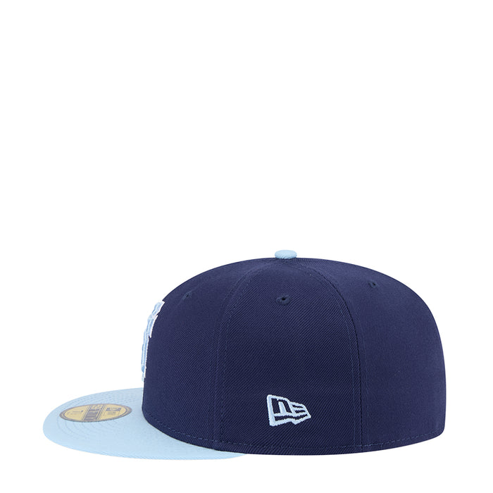 Two-tone baseball cap with dark navy crown, light blue brim, New Era logo patch