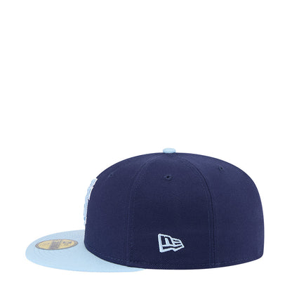 Two-tone baseball cap with dark navy crown, light blue brim, New Era logo patch