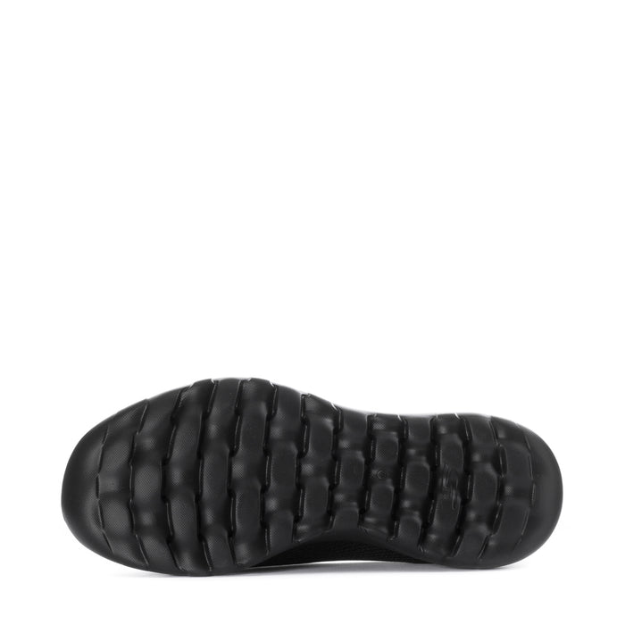 Women's black slip-on walking shoes, outsole view with textured tread pods