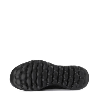 Women's black slip-on walking shoes, outsole view with textured tread pods