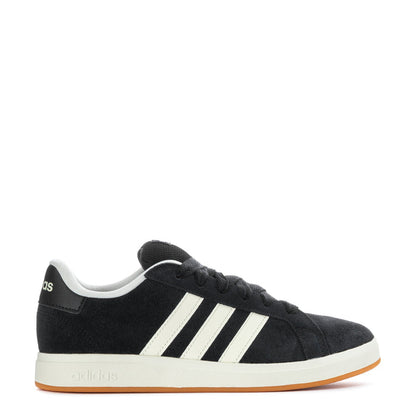 Black Adidas sneakers with white three stripes and gum outsole, side view.