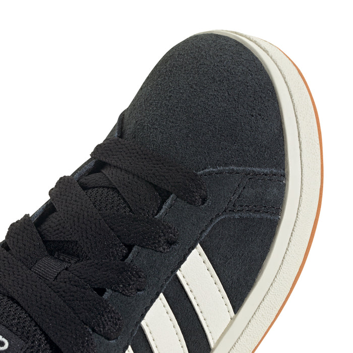 Black Adidas sneaker upper close-up with lace and white side stripes, gum sole edge.