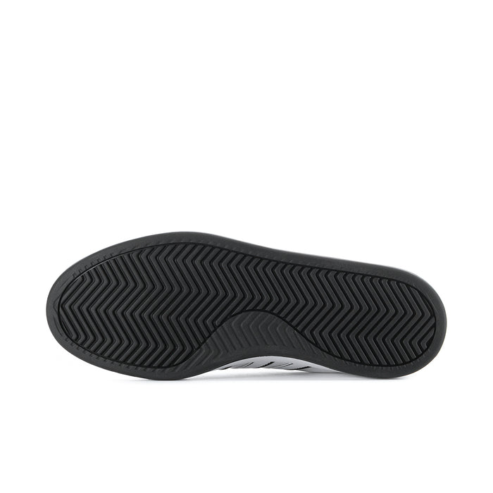 Men's adidas sneaker outsole with dark zigzag tread pattern and rubber texture.