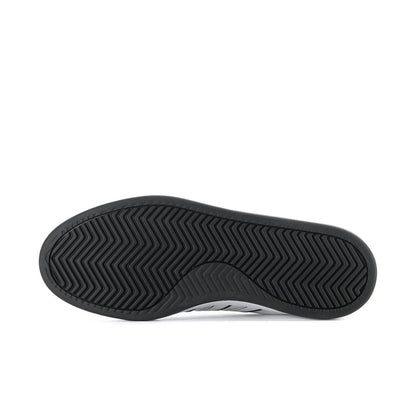 Men's adidas sneaker outsole with dark zigzag tread pattern and rubber texture.