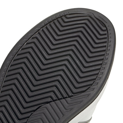 Men's adidas outsole close-up with deep chevron tread for traction.