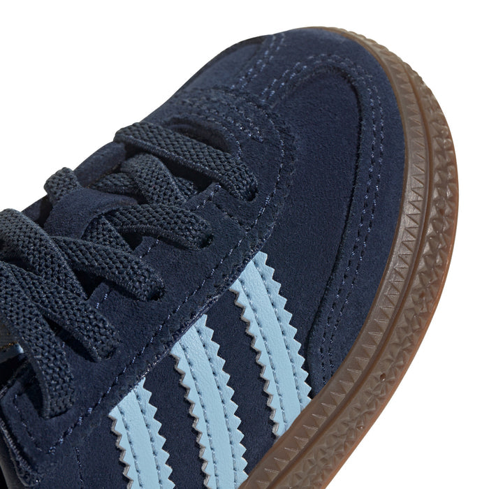 Close-up toddler navy suede toe with light blue stripes and textured gum sole edge
