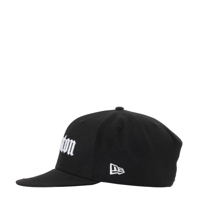 Black snapback cap with white side logo and New Era emblem