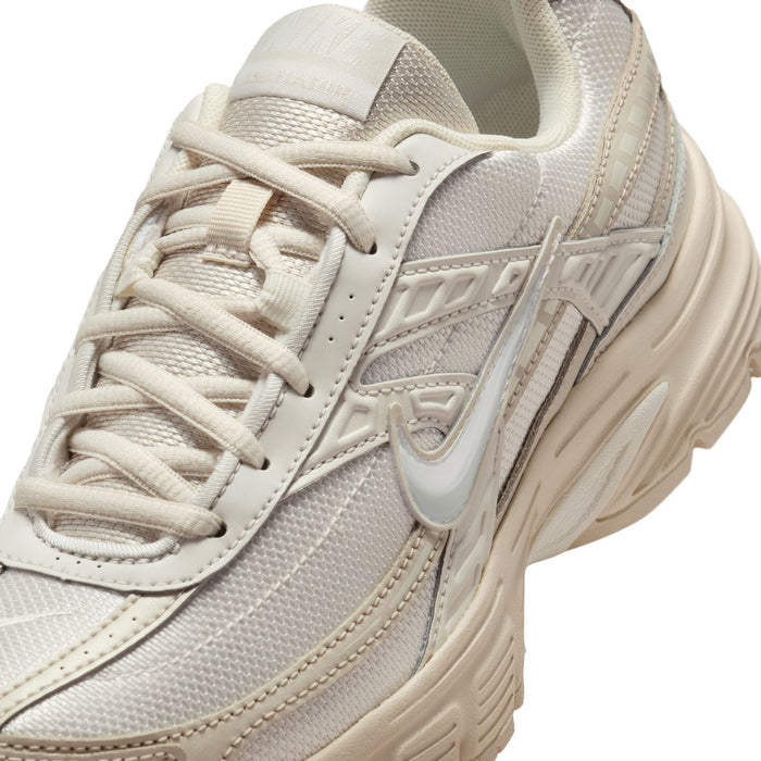 Womens sneaker close-up, sail mesh upper with lace eyelets and woven logo panel