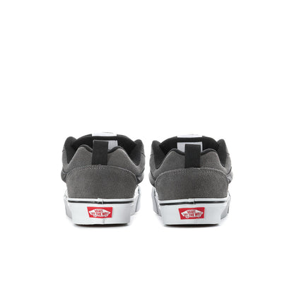 Men's sneaker heel view with red and white side patch, black tongue, white sole