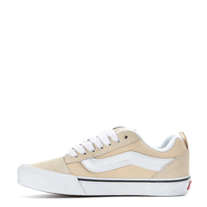 Beige and white low-top women's sneakers with white laces and blue-trim side panel