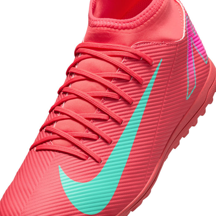 Men's red turf soccer shoes close-up of laces and turquoise swoosh stripe
