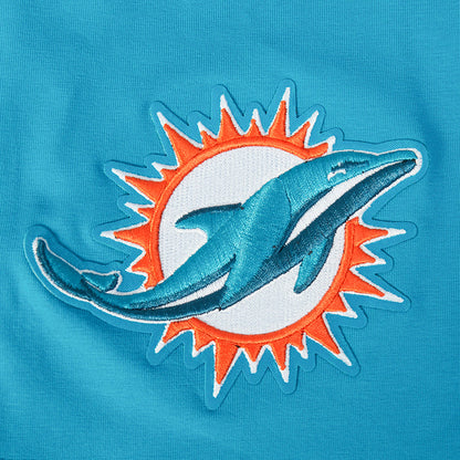 Close-up of Dolphins team logo patch on teal T-shirt sleeve