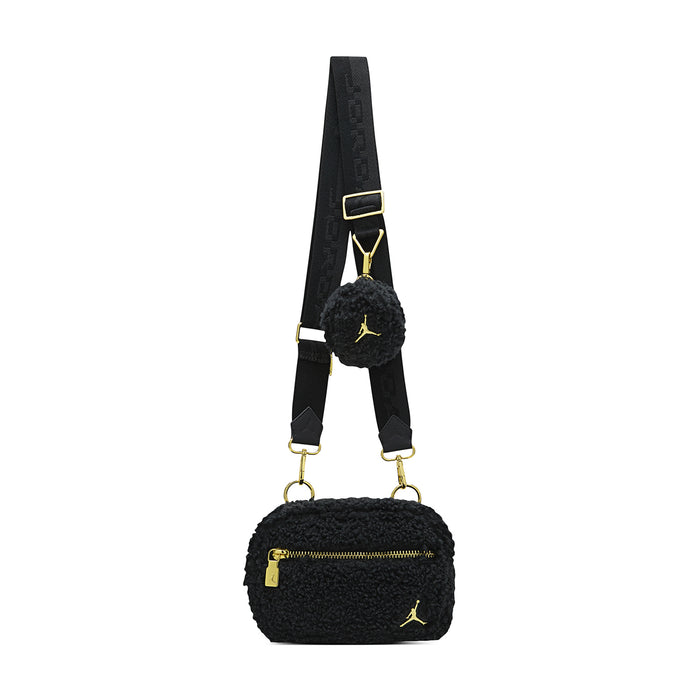 Black sherpa camera bag with adjustable strap, gold rings, and fuzzy side pouch