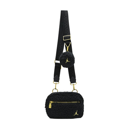 Black sherpa camera bag with adjustable strap, gold rings, and fuzzy side pouch