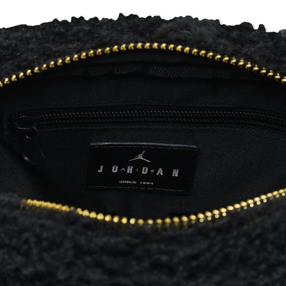 Black interior pocket with leather brand label and gold zipper on sherpa camera bag