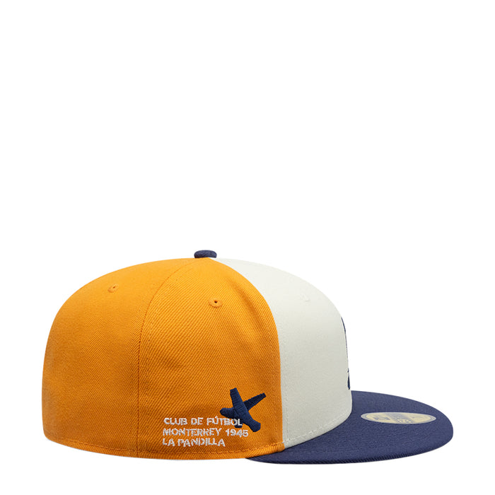 Three-tone baseball cap in gold and white with navy side panel logo