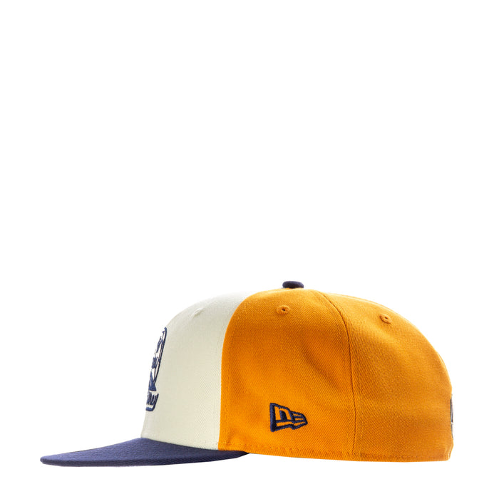 Three-tone baseball cap with orange front panels and navy New Era flag logo