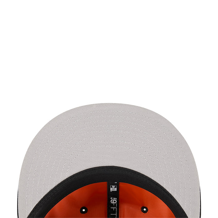 White baseball cap with orange interior underside and black top eyelets.