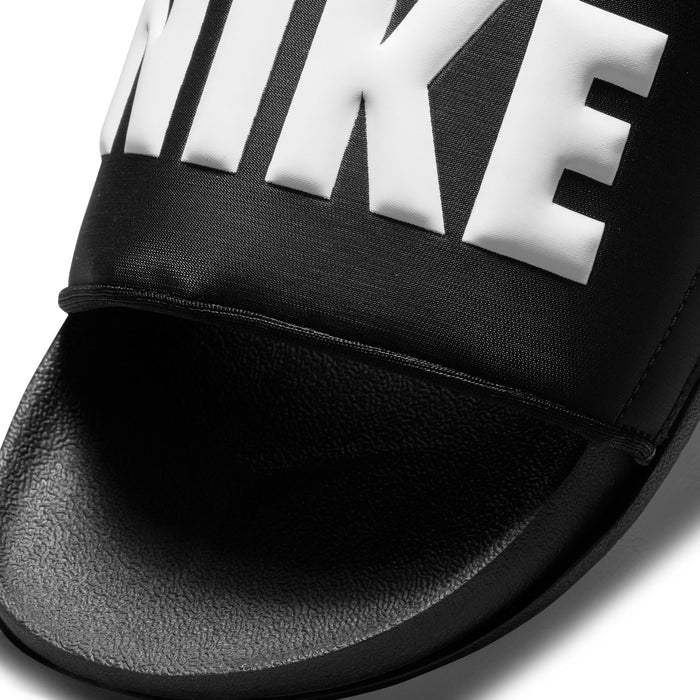 Close-up of black slide sandal strap with white Nike lettering